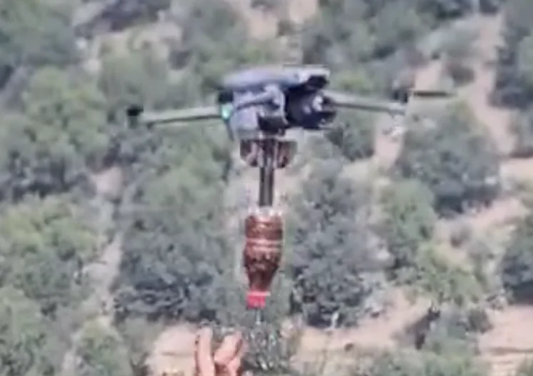Frame at 00:39: Small mortar shell suspended beneath the drone