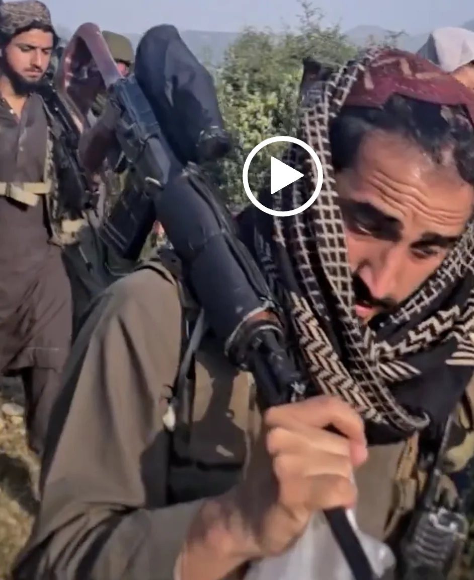 Frame at 05:24: SVD-pattern rifle carried on the shoulder