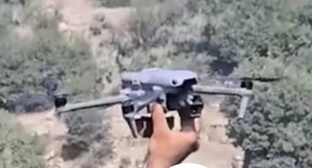 Frame at 00:38: Quadcopter held before take-off