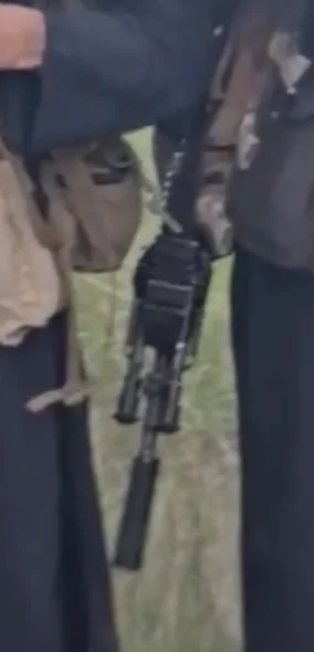 Frame at 08:56: Carbine with suppressor and folding bipod