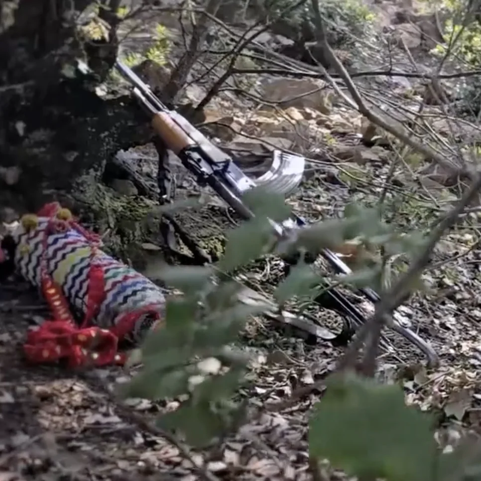 Frame at 01:55: AK-pattern rifles carried by several fighters