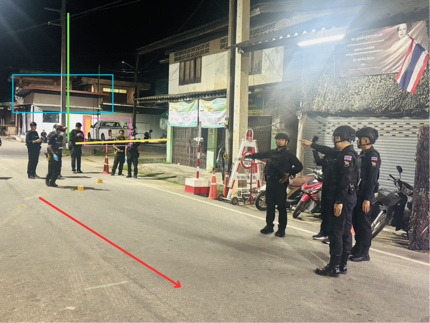 Investigating officers standing at a road junction after the attack, with the white pickup truck and electricity pole visible behind them.